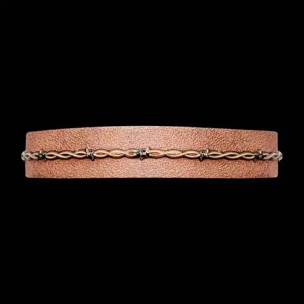 Add a rugged touch to any western outfit with our Johnny Western Cuff Bracelet. Crafted on a Copper base with our signature matted finish and 3D Bronze barbed wire. Order it now! 